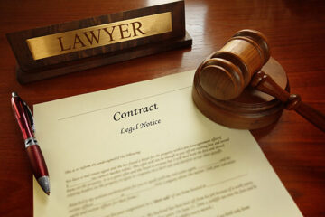 Van Gils Law Firm, registered agent attorney in northern virginia, image shows a legal contract and gavel on a desk.